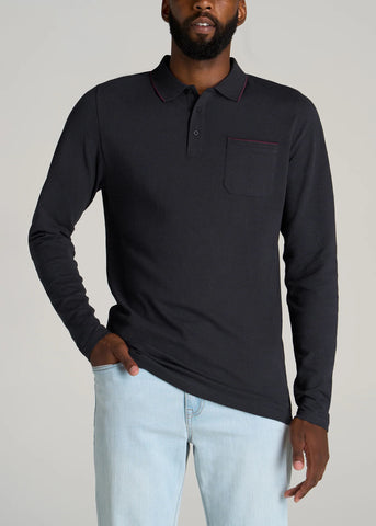 Men wearing black long sleeve polo shirt with light colored jeans 