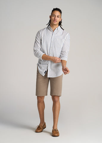 Man wearing tan colored chino shorts with long sleeve button up shirt