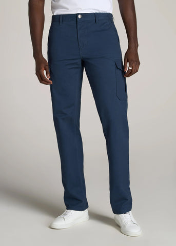 Closeup of man standing wearing dark blue cargo pocket pants